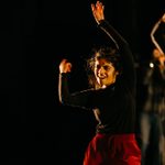 CoLab_24_Wk1_Showcase_Laban_SLG_APPROVED_web-res_8116_rgb A student wearing a black top and red trousers dances on stage