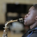 FFP26759-scaled (1) Young man playing the saxophone, in profile with eyes closed in concentration