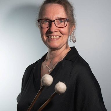 Kate-Hext-Eyre-aspect-ratio-750-750 Kate is a white woman, she wears her hair tied back and has dark framed glasses.
